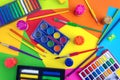 Flat lay top view of art workplace, water colors and crayon pastel chalks on yellow, orange, red, green Royalty Free Stock Photo