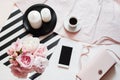 Flat lay. Top view. Beauty blog concept. Woman accessories, , bouquet of roses and pions, coffee and phone on white background Royalty Free Stock Photo