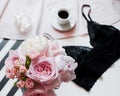 Flat lay. Top view black lace lingerie. Beauty blog concept. Bouquet of roses and pions, coffee on white background