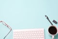 Flat lay top view closeup modern office desk Workspace with eye glasses, office supplies, pen,watches, computer keyboard,white Royalty Free Stock Photo