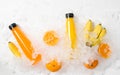 Flat lay top view colorful yellow and orange juice bottles with bananas in ice Royalty Free Stock Photo