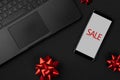 Flat lay top view composition laptop, smartphone and bow. Black friday sale mockup