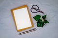 Blank greeting, condolence or invitation mockup with brown envelope, handmade white paper and ivy