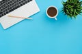 Flat lay top view copy space of a working space with laptop, a coffee cup and little grass. Royalty Free Stock Photo