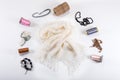 Flat lay top view on crumpled handmade white woolen scarf with different accessaries