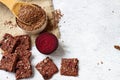 Flat lay top view crunchy flax seeds wooden spoon and crispbread with raw round piece of beetroot on white background