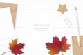 Flat lay top view elegant white composition letter kraft paper envelope autumn maple leaf pencil eraser and star shape craft on