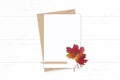 Flat lay top view elegant white composition letter kraft paper envelope autumn red maple leaf pencil and vintage metal scissors on