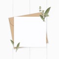 Flat lay top view elegant white composition letter kraft paper envelope nature leaf flower plant on wooden background Royalty Free Stock Photo