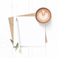 Flat lay top view elegant white composition letter kraft paper envelope nature leaf pencil and coffee on wooden background