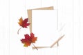 Flat lay top view elegant white composition letter kraft paper envelope pencils autumn maple leaf and tag on wooden background Royalty Free Stock Photo