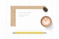 Flat lay top view elegant white composition letter kraft paper envelope pine cone yellow pencil and coffee on wooden background