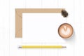 Flat lay top view elegant white composition letter kraft paper envelope pine cone yellow pencil and coffee on wooden background