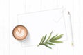 Flat lay top view elegant white composition paper botanic garden plant tarragon leaf tag pencil and coffee on wooden background