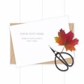 Flat lay top view elegant white composition paper kraft envelope autumn maple leaf and vintage metal scissors on wooden background