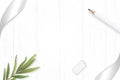 Flat lay top view elegant white composition silver ribbon pencil tarragon leaf and eraser on wooden floor background