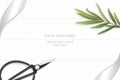 Flat lay top view elegant white composition silver ribbon tarragon leaf and vintage metal scissors on wooden floor background