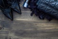 Flat lay, top view of female fashion accessories. Black handbag, high heel shoes and perfume on wooden background with copy space. Royalty Free Stock Photo