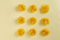 Flat lay top view fettuccine pasta on a yellow pastel background copy space