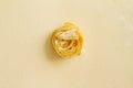 Flat lay top view fettuccine pasta on a yellow pastel background copy space