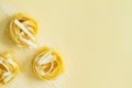 Flat lay top view fettuccine pasta on a yellow pastel background copy space