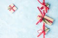 Flat lay top view four christmas gift boxes in craft paper with red ribbons on light blue Royalty Free Stock Photo