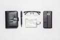 Flat lay top view gentlemen's accessories on white background. Eyeglasses, perfumes, smartphone, pen, diary notebook on white Royalty Free Stock Photo