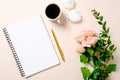 Flat lay, top view girls diary, coffee cup and flowers on pink background. Feminine desk workspace, home office table desk