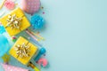 Flat lay top view image featuring celebratory props, lollipops, gift boxes, party hats, blower, candles blue background