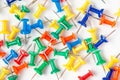 Flat lay top view of many colorful push pins on white background Royalty Free Stock Photo