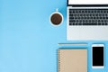Flat lay top view mockup photo of working space with laptop, smartphone, coffee and stationary on blue pastel background. Royalty Free Stock Photo