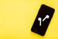 Flat lay top view mockup photo of working space with smartphone, headphones on yellow background. Back to school, online Royalty Free Stock Photo