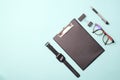 Flat lay top view office desk Workspace with blank clip board, eye glasses, office supplies, pen,watches,and coffee cup on Royalty Free Stock Photo