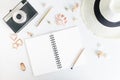 Flat lay top view notepad mockup: pencils, black beads, straw hat, seashells on white background. Clean and bright. Travel concept Royalty Free Stock Photo