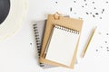 Flat lay top view notepad mockup: pencils, black beads, straw hat on white background. Clean and bright Royalty Free Stock Photo