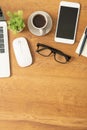 Flat lay of top view office desk wooden table with laptop and smartphone and equipment Royalty Free Stock Photo