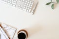 Flat lay top view office desk. Workspace with keyboard and office supplies, pencil, green leaf with coffee on white background. Royalty Free Stock Photo