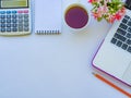 Calculator and flower on white background.