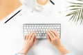 Flat lay, top view office table desk. Woman typing on keyboard. Royalty Free Stock Photo