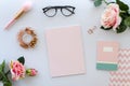 Women accessories including blank paper for lettering, notepad, black glasses and roses on white background. beauty Royalty Free Stock Photo