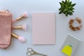 Flat lay, top view office table desk workspace with office and beauty with brushes, blank paper and plant on white Royalty Free Stock Photo