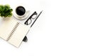 Flat lay, top view office table desk. Workspace with blank, office supplies, pencil, green leaf, and coffee cup on white Royalty Free Stock Photo
