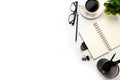 Flat lay, top view office table desk. Workspace with blank, office supplies, pencil, green leaf, and coffee cup on white Royalty Free Stock Photo