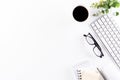 Flat lay, top view office table desk. Workspace with keyboard, office supplies, green leaf, and coffee cup with copy space on Royalty Free Stock Photo