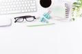 Flat lay, top view office table desk. Workspace with keyboard, office supplies, pencil, green leaf, and coffee cup with copy space Royalty Free Stock Photo