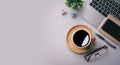 Flat lay, top view office table desk. Workspace with keyboard, office supplies, pencil, green leaf, and coffee cup on gray Royalty Free Stock Photo