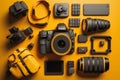 Flat lay or top view of photographer workplace with dslr camera, lens, pen tablet and camera accessories with yellow background. Royalty Free Stock Photo