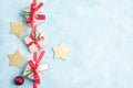 Flat lay top view three christmas gifts and gold stars on blue Royalty Free Stock Photo