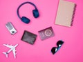 Flat lay top view of traveler photographer accessories on pink background Royalty Free Stock Photo