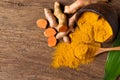 Turmeric curcumin powder with fresh rhizome on wood background Royalty Free Stock Photo